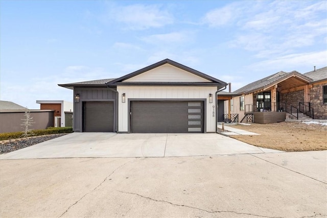 view of front of property featuring an attached garage, board and batten siding, and driveway