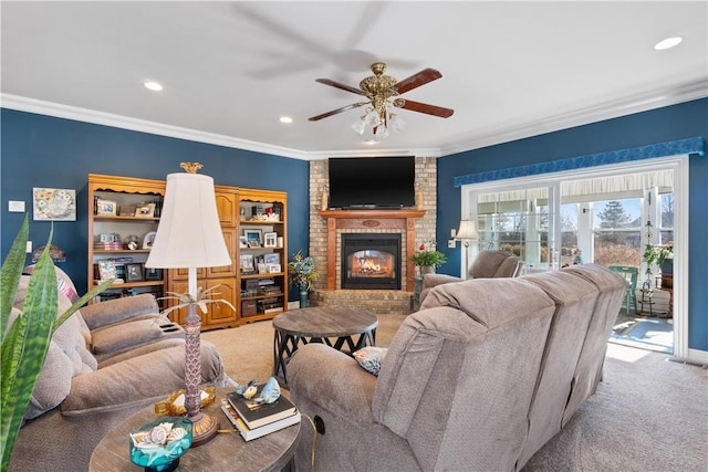 living room featuring crown molding, carpet floors, a brick fireplace, and ceiling fan