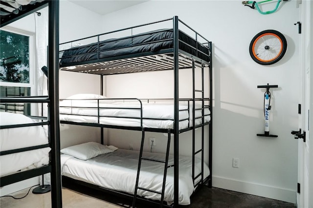 bedroom featuring concrete floors