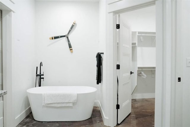 bathroom with concrete floors and a bathing tub