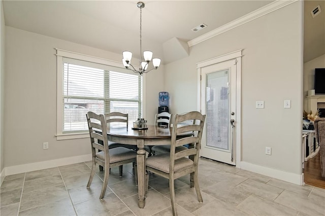 dining room with an inviting chandelier and ornamental molding