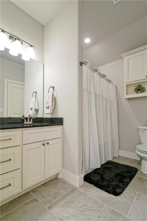 bathroom with toilet, vanity, tile patterned flooring, and a shower with shower curtain