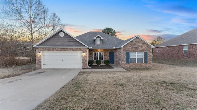 view of front of property featuring a yard and a garage