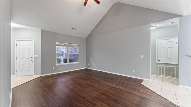 unfurnished living room with ceiling fan, high vaulted ceiling, and light hardwood / wood-style floors