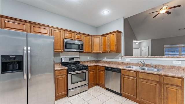 kitchen featuring sink, light tile patterned floors, ceiling fan, stainless steel appliances, and decorative backsplash