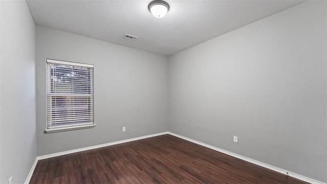 empty room featuring wood-type flooring