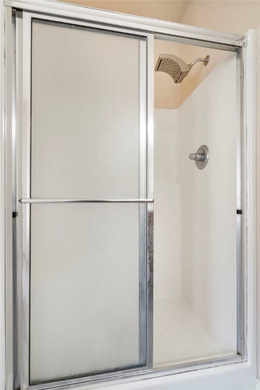 bathroom with a shower with shower door