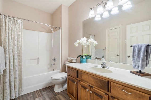 full bathroom featuring vanity, hardwood / wood-style flooring, shower / tub combo, and toilet