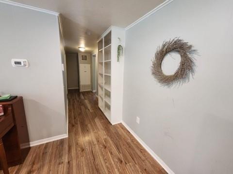 hall with crown molding and dark hardwood / wood-style flooring