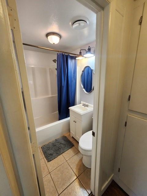 full bathroom with vanity, toilet, shower / bath combination with curtain, and tile patterned floors