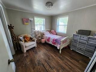 bedroom featuring crown molding and dark hardwood / wood-style floors