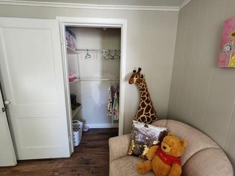 interior space featuring a closet, ornamental molding, and dark hardwood / wood-style floors