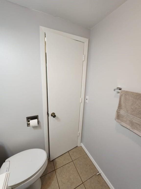 bathroom featuring toilet and tile patterned flooring