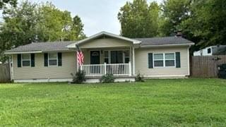 single story home with covered porch and a front lawn