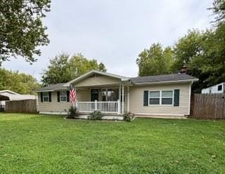 ranch-style home with a front lawn and a porch