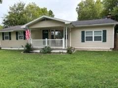 single story home with covered porch and a front lawn