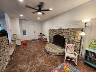 living room featuring ceiling fan and a fireplace