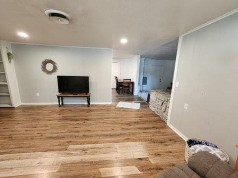 living room featuring light hardwood / wood-style floors and ornamental molding