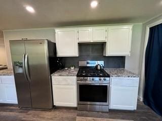 kitchen featuring stainless steel appliances and white cabinetry