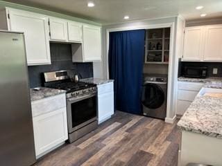 kitchen featuring white cabinetry, washer / dryer, light stone countertops, and stainless steel appliances