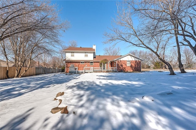 snow covered property with a deck