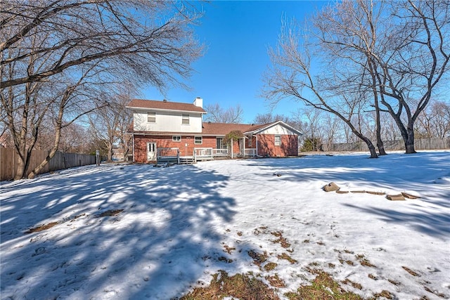 view of snow covered rear of property