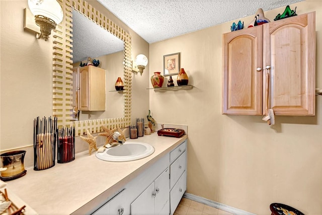 bathroom featuring vanity, tile patterned floors, and a textured ceiling