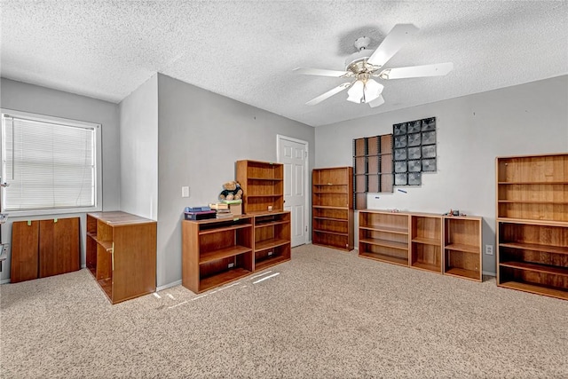 interior space with ceiling fan and a textured ceiling