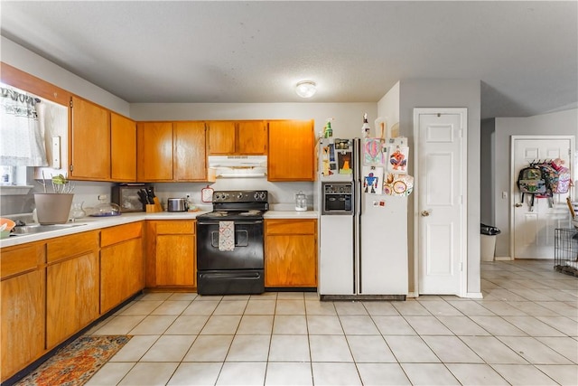 kitchen with light tile patterned floors, sink, electric range, and white fridge with ice dispenser