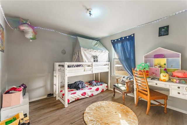 bedroom with hardwood / wood-style flooring