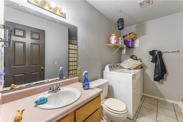 bathroom featuring toilet, a textured ceiling, tile patterned floors, and vanity