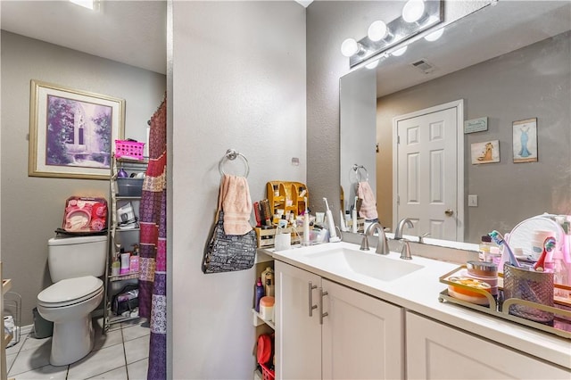 bathroom with vanity, toilet, and tile patterned flooring