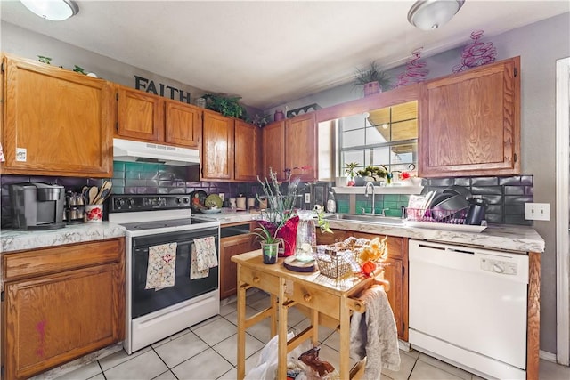 kitchen featuring sink, white appliances, tasteful backsplash, and light tile patterned flooring