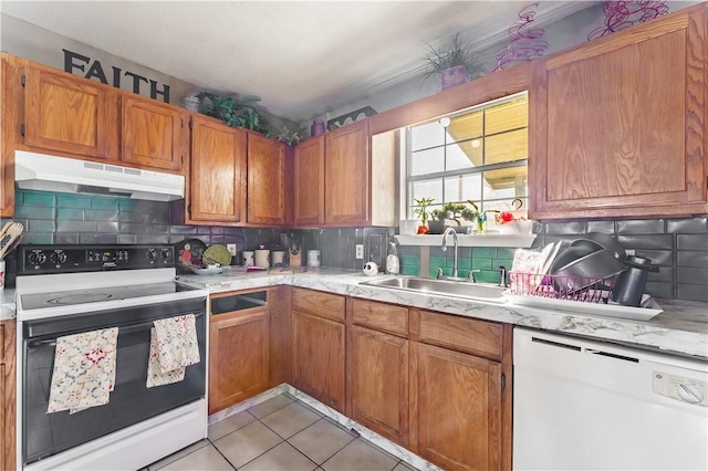 kitchen with sink, white appliances, tasteful backsplash, and light tile patterned floors