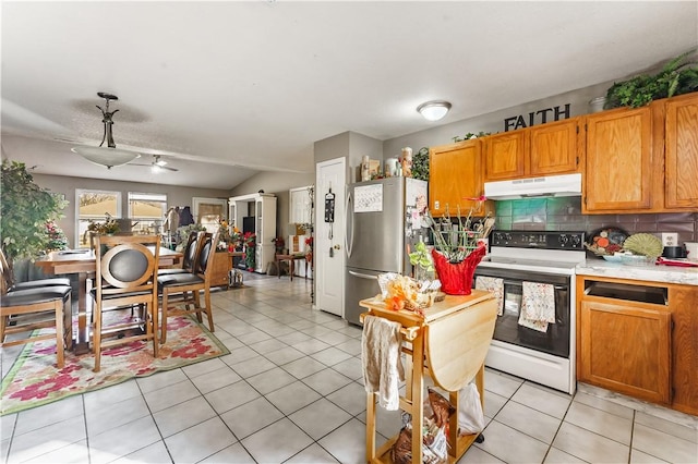 kitchen featuring tasteful backsplash, white range with electric cooktop, stainless steel fridge, ceiling fan, and light tile patterned floors