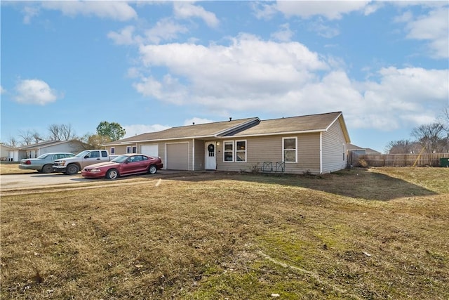 ranch-style home with a garage and a front lawn