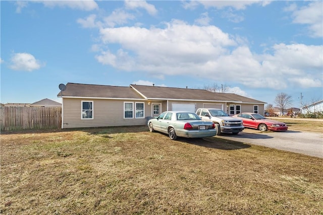 single story home featuring a garage and a front lawn