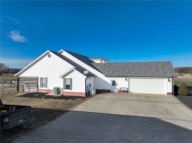 view of property exterior featuring a garage and central air condition unit