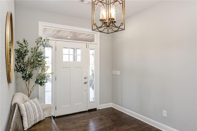 entrance foyer featuring dark hardwood / wood-style floors and a chandelier