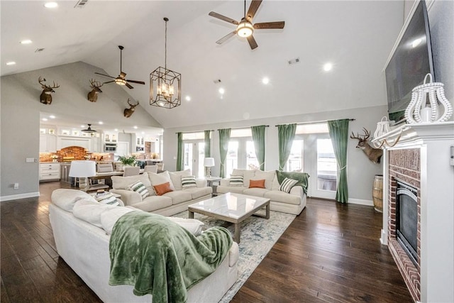 living room featuring a brick fireplace, dark hardwood / wood-style floors, high vaulted ceiling, and ceiling fan