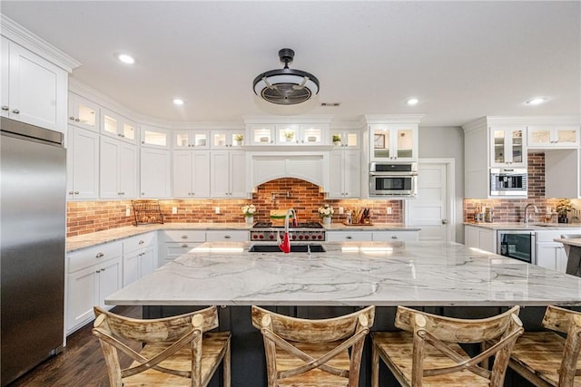 kitchen featuring white cabinetry, a breakfast bar area, and stainless steel appliances