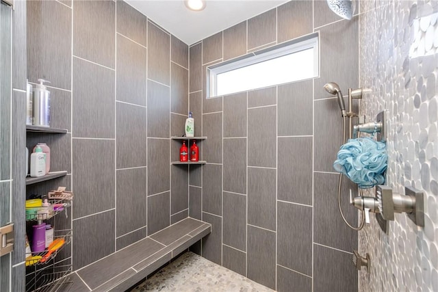 bathroom with a tile shower