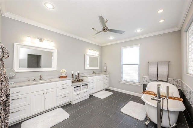 bathroom with a bathing tub, ornamental molding, vanity, and ceiling fan