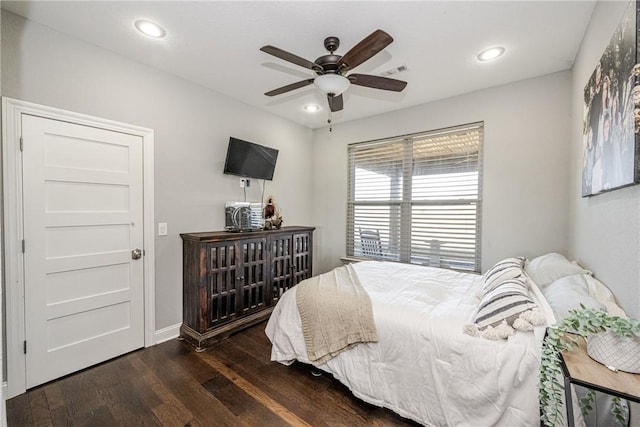 bedroom with dark hardwood / wood-style flooring and ceiling fan