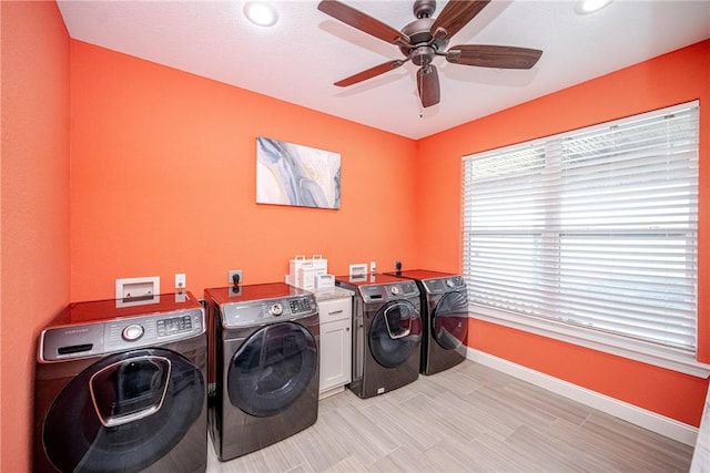 washroom with cabinets, independent washer and dryer, ceiling fan, and light wood-type flooring