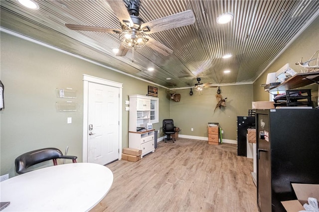 interior space featuring ceiling fan, ornamental molding, and light hardwood / wood-style flooring