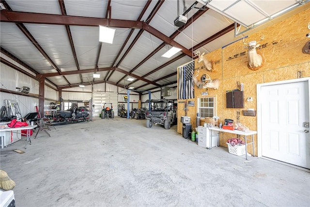 garage featuring a garage door opener and a workshop area