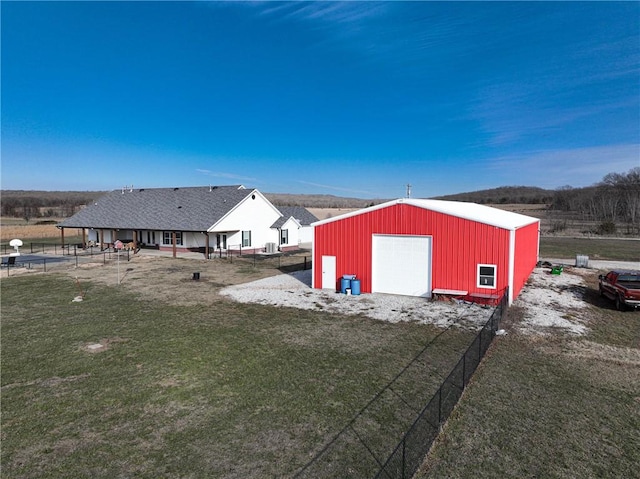 exterior space featuring a garage and an outbuilding