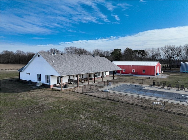 view of swimming pool with an outbuilding, a patio, and a lawn