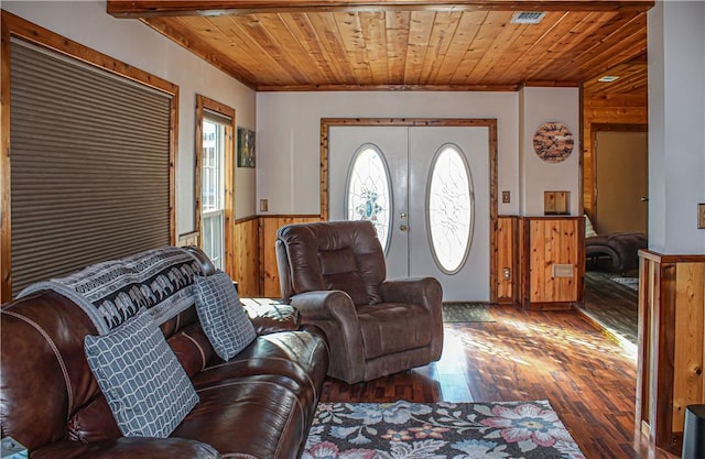 living room featuring dark hardwood / wood-style floors, wooden ceiling, french doors, and wood walls